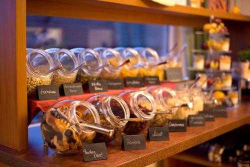 a display of breads and pastries on a shelf at Hotel Heikenberg in Bad Lauterberg