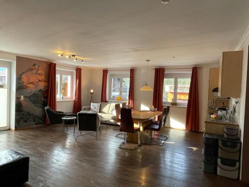 a living room with a couch and a table and chairs at Wonder & Wander in Ehrwald