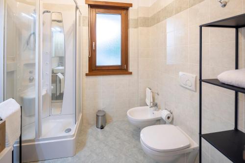 a bathroom with a toilet and a shower and a sink at - Luxury Apartment With Garden - in Monfalcone