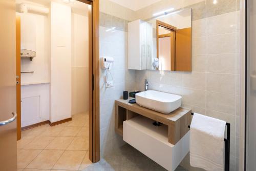 a bathroom with a sink and a mirror at - Luxury Apartment With Garden - in Monfalcone