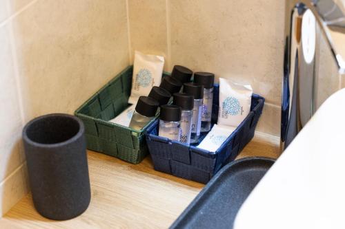 a group of bottles of hair products sitting on the floor at - Luxury Apartment With Garden - in Monfalcone