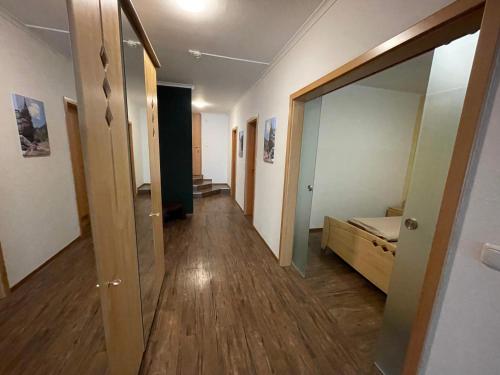 a hallway with a large mirror and a hallway with a hallway at Wonder & Wander in Ehrwald