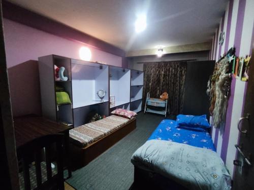 a small room with a bed and a bunk bed and a bed at Puru Boutique Home "PBH", Private Room, Apartment, Thamel, Swoyambhu, Benchen Monastery, Kathmandu, Nepal in Kathmandu