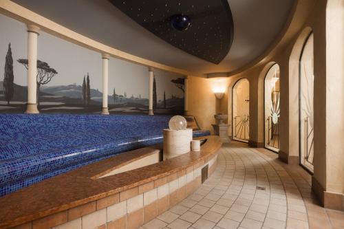 a room with a swimming pool in a house at miaflor Familien- & Aktivresort in Ried im Oberinntal