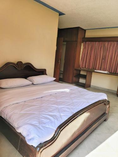 Ένα ή περισσότερα κρεβάτια σε δωμάτιο στο Nairobi Glory Palace Hotel