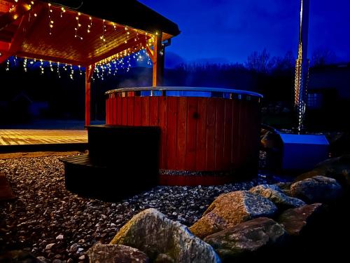 a red barrel in a yard with christmas lights at Przystanek Śnieżka in Kowary