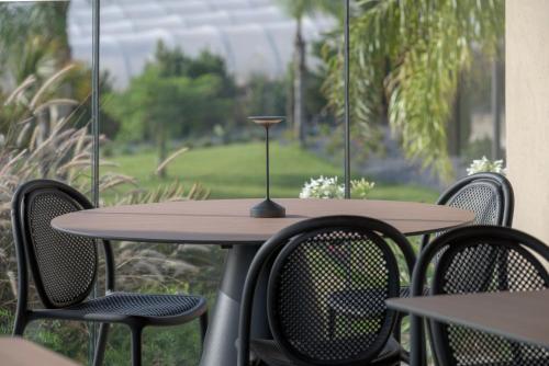 a wooden table and chairs on a patio at Terreforti Luxury Village in Agrigento