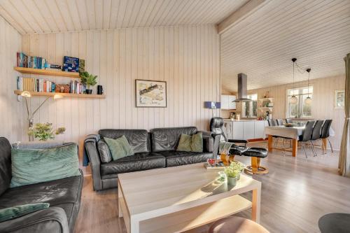 a living room with a couch and a table at Beautiful Holiday Home With A Lovely View Of The Fjord And The Sea in Vestervig