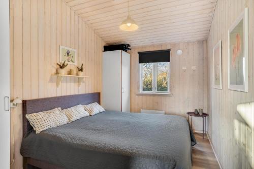 a bedroom with a bed in a small room at Beautiful Holiday Home With A Lovely View Of The Fjord And The Sea in Vestervig