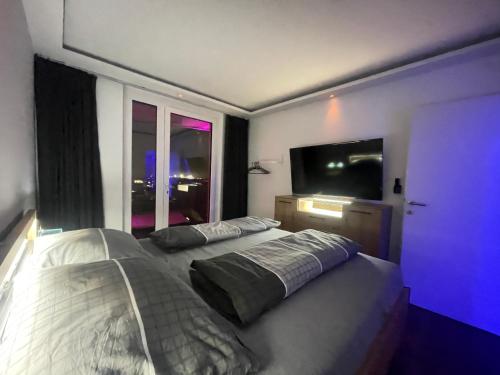 a bedroom with two beds and a large window at 100 qm Penthouse, Self-Check-In, 2 Parkplätze in Graz