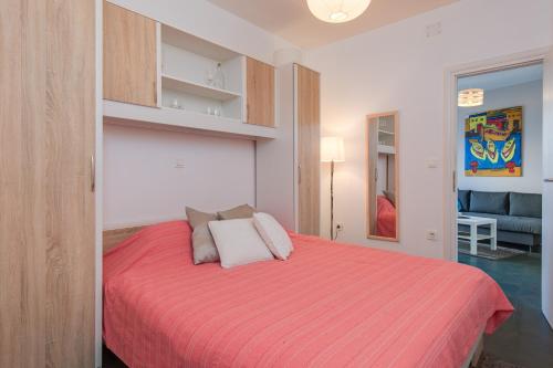 a bedroom with a bed with a red blanket at Apartment Lauro Opatija, ground floor, parking, near sea in Opatija