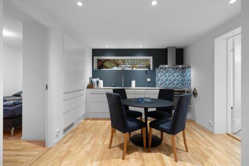 a kitchen with a table and chairs in a room at Apartment in Tromsø in Tromsø