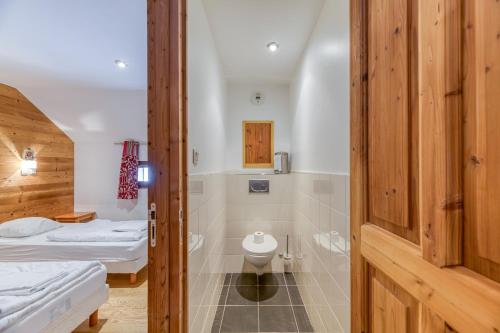 a bathroom with two beds and a toilet in a room at Chalet le Regain in Villard-Reculas