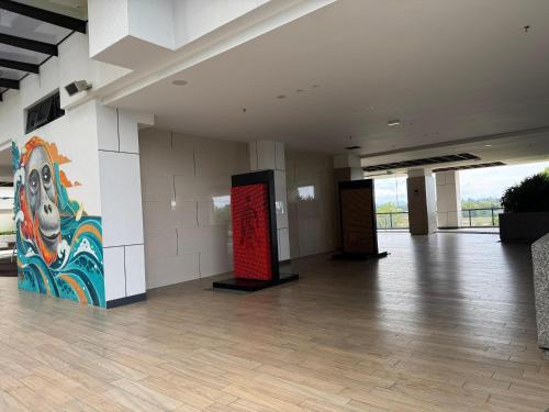 a large room with a large painting on the wall at K Avenue High Floor Studio Balcony with Sunrise View in Kota Kinabalu