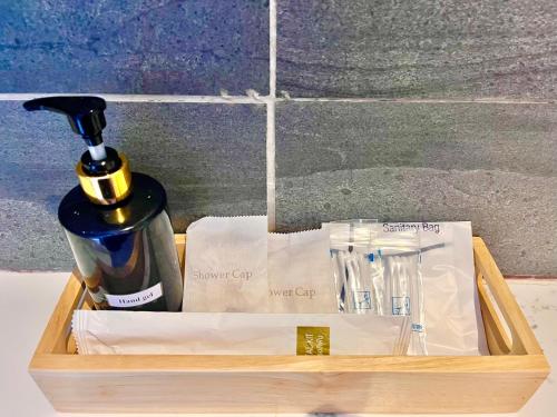 a wooden tray with a bottle of soap and a perfume at The Chic Lipe in Ko Lipe