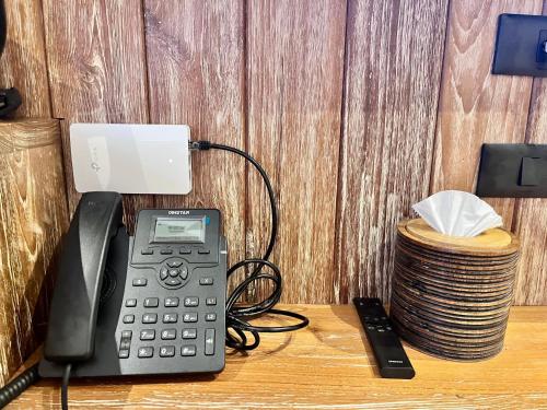 a phone sitting on top of a desk next to a telephone at The Chic Lipe in Ko Lipe