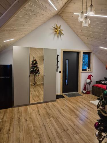 a living room with a christmas tree on the wall at Apartament z prywatna wanną hydromasaż - U Parów in Białka Tatrzanska