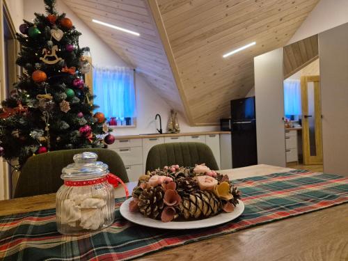 a plate of food on a table with a christmas tree at Apartament z prywatna wanną hydromasaż - U Parów in Białka Tatrzanska