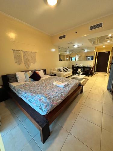 a bedroom with a large bed in a room at Click Stay - JLT - Studio & Balcony Lakes view Entire Apartment -RA in Dubai