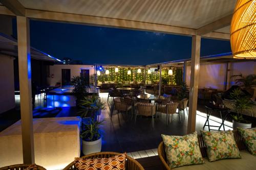 an outdoor patio with tables and chairs at night at ACR Luxury Hotel in Mohali
