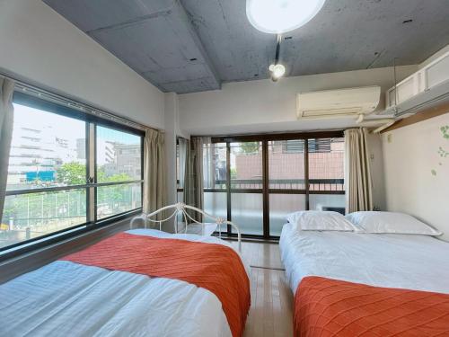 Ένα ή περισσότερα κρεβάτια σε δωμάτιο στο Ueno Iriya Hotel