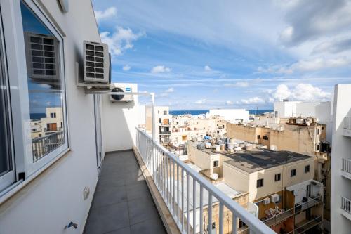a balcony with a view of a city at New and Modern home in Bugibba, great location in St Paul's Bay