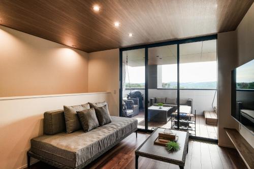 a living room with a couch and a table at MIRATIO The Supreme in Onna