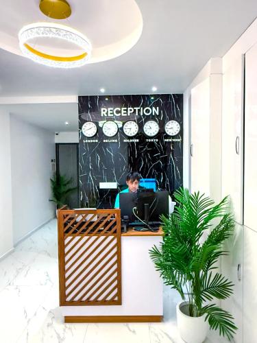 a man sitting at a desk in an office at Blue Sky Beach in Hulhumale