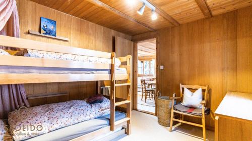 a bunk bed room with two bunk beds and a desk at Ferienhaus Golmenheim, Riederalp in Riederalp