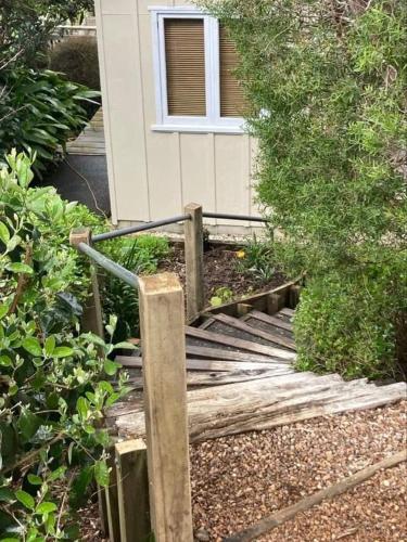 a wooden bridge in front of a house at Waiwurri - at the Beach in Palm Beach