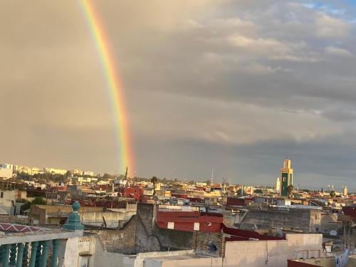 a rainbow in the sky over a city at Riad Malak in Meknès