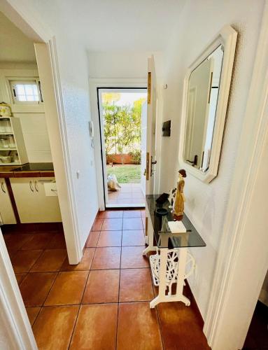 a hallway with a tile floor and a mirror at Buganvilla 56 in Roquetas de Mar