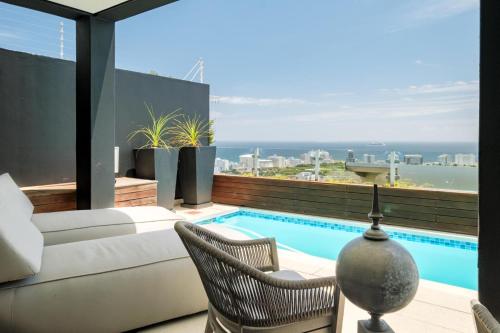 a living room with a couch and a swimming pool at Villa Alexa in Cape Town