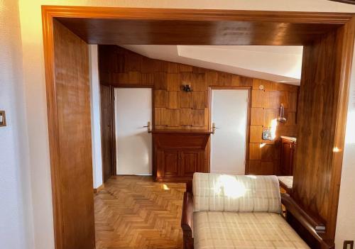 a living room with wooden walls and a couch at Casa Natura, Tradizione e Relax in Roccaraso