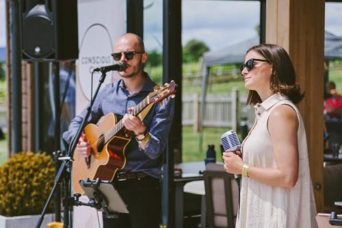 a man and a woman holding microphones and a guitar at Lympstone Manor Hotel Restaurant & Vineyard - Relais & Chateaux in Exmouth