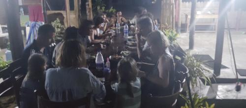 a group of people sitting around a long table at Scoop Cabana Kitesurfing in Kalpitiya