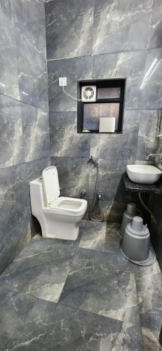 a bathroom with a toilet and a sink at Gotawala Villa 16 in Daman