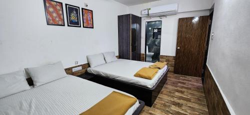 a small room with two beds and a closet at Gotawala Villa 16 in Daman