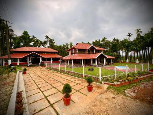 a house with a fence in front of it at Haveli Holiday Home in Mudigere