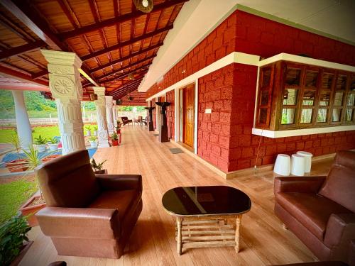 a living room with a couch and a table at Haveli Holiday Home in Mudigere