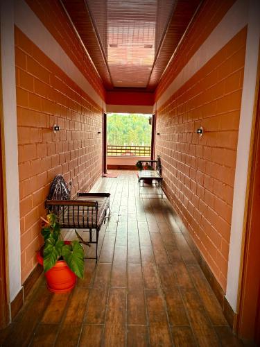 an empty hallway with two benches and a window at Haveli Holiday Home in Mudigere