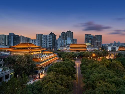 a city skyline with tall buildings and a street at Country Inn&Suites By Radisson, Xi'an Bell and Drum Tower Flagship in Xi'an