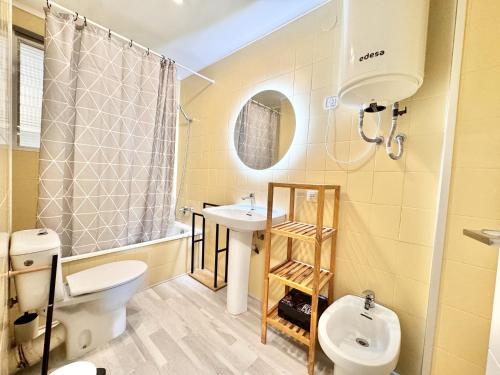 a bathroom with a white toilet and a sink at Mediterranean Way - Pineda 1 in La Pineda