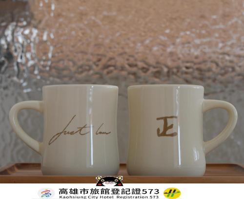 two coffee mugs with the words first kiss written on them at Just Inn Kaohsiung in Kaohsiung