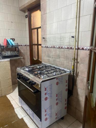 a stove top oven sitting in a kitchen at Asyut Cozy Nile view apartment in Asyut