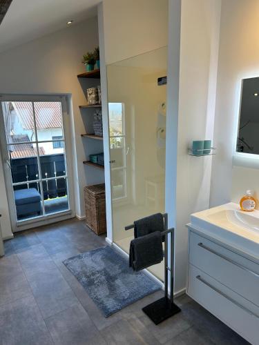 a bathroom with a sink and a mirror at Alexanders Mountain Loft in Bad Feilnbach