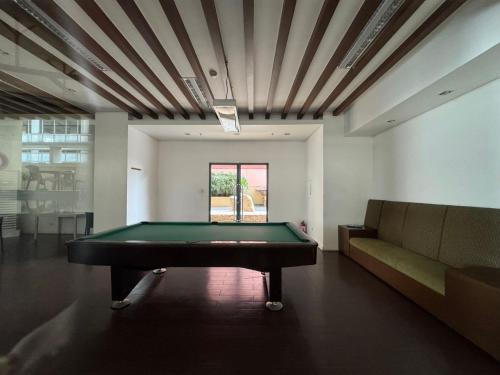 a living room with a pool table and a couch at Beachfront U.S. Embassy Family Retreat. in Manila