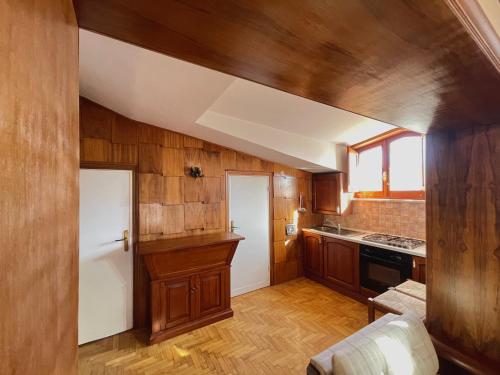 a kitchen with wooden walls and wooden floors at Casa Natura, Tradizione e Relax in Roccaraso