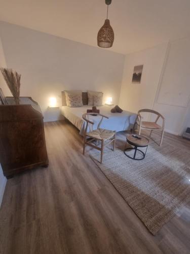 a living room with a bed and a table and chairs at Chambre DURFORT in Sault-de-Vaucluse