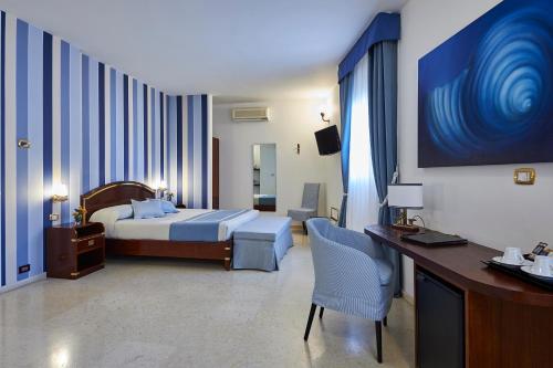 Letto o letti in una camera di Corte Di Nettuno - CDSHotels
